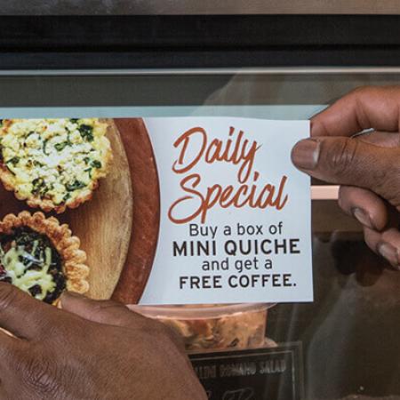 A hot deli glass case signage made with Nekoosa Ztac™ - an ultra low-tack and repositionable polyester film designed for easy application and removal on very smooth indoor surfaces.